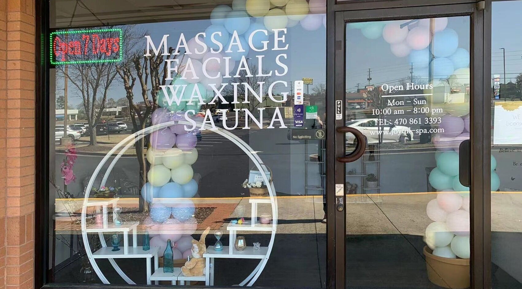 Front of Joyful Massage Day Spa LLC in Conyers, Georgia, US with open hours and colorful balloons.