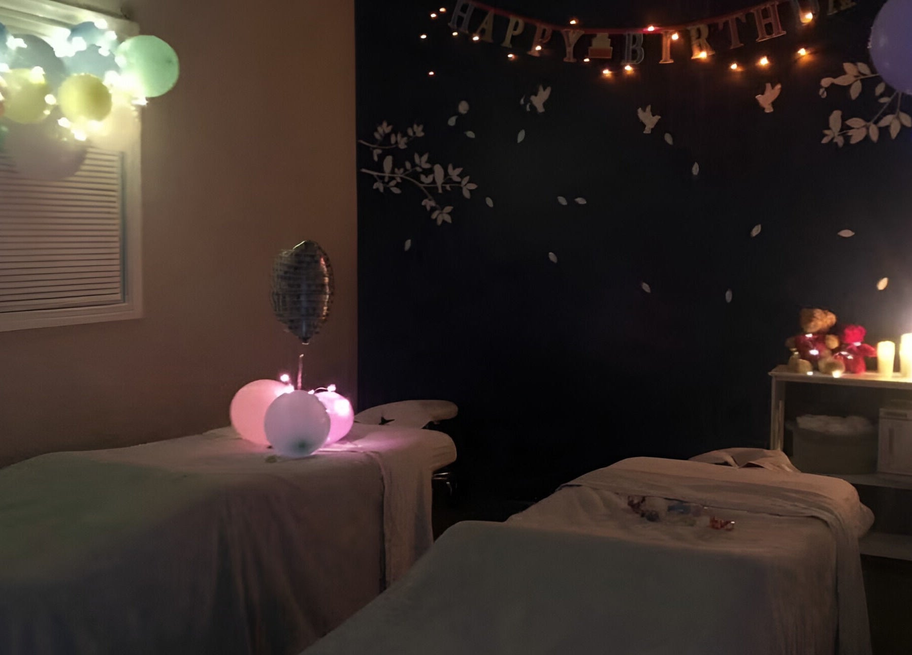 Decorated massage room at Joyful Massage Day Spa LLC, Conyers, Georgia, US. Cozy ambiance with balloons and lighting.