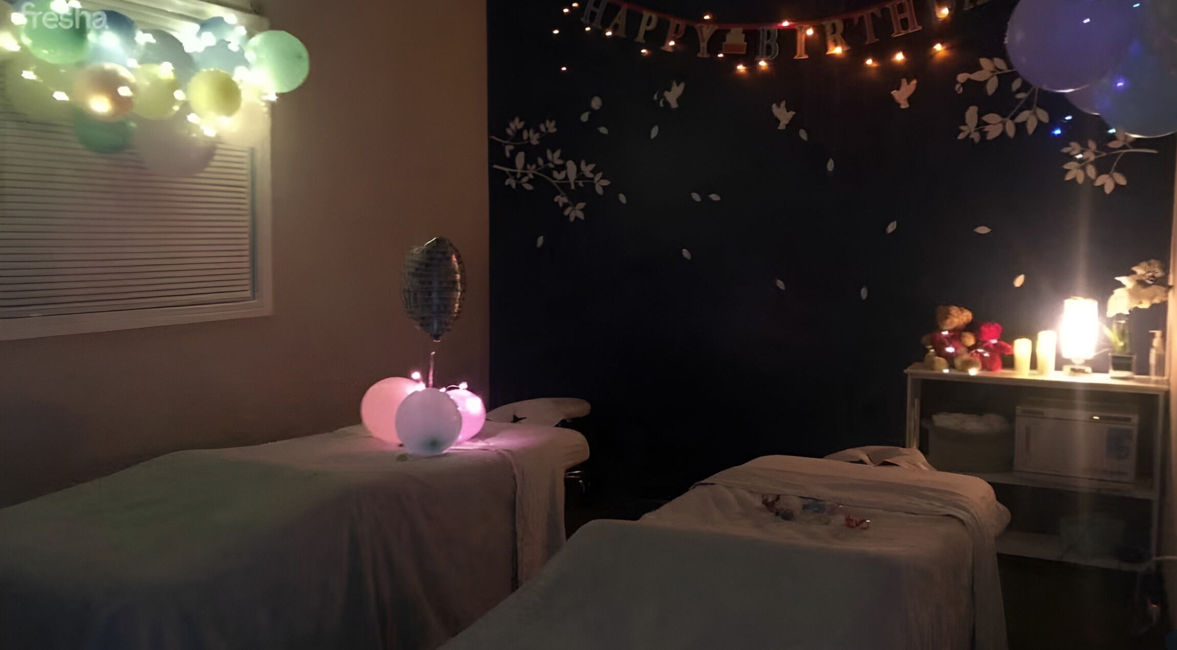 Decorated massage room at Joyful Massage Day Spa LLC, Conyers, Georgia, US. Cozy ambiance with balloons and lighting.