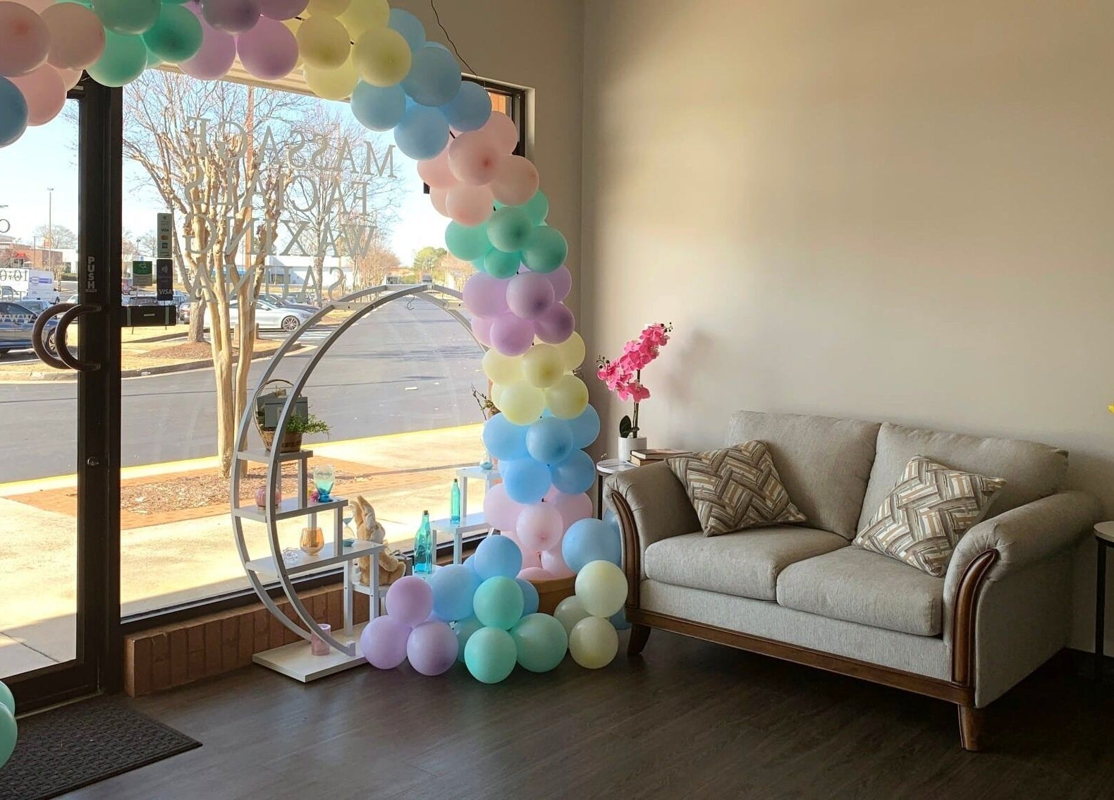 Inviting seating area with pastel balloon arch at Joyful Massage Day Spa LLC, Conyers, Georgia, US.