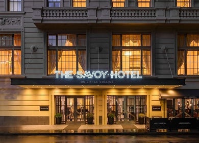 Elegant facade of The Savoy Hotel - V Hotel Spa in Melbourne, VIC, AU, showcasing its illuminated entrance.