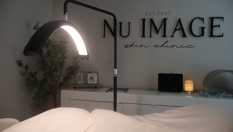 Relaxing treatment room at Nu Image, Lowton, England, GB with ambient lighting and tranquil decor.