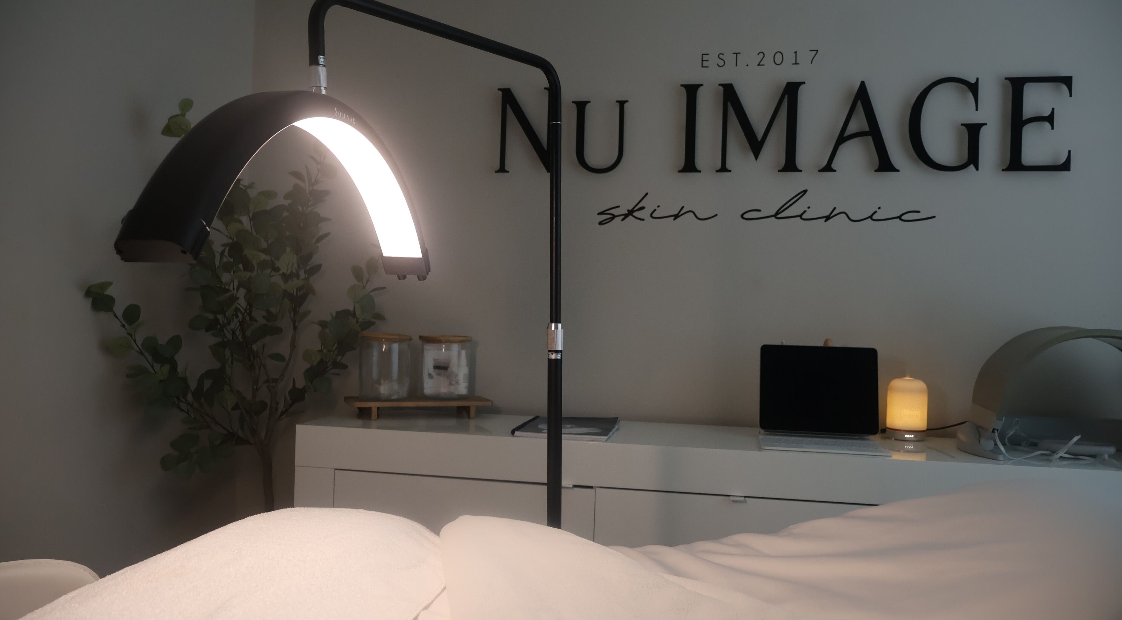 Relaxing treatment room at Nu Image, Lowton, England, GB with ambient lighting and tranquil decor.