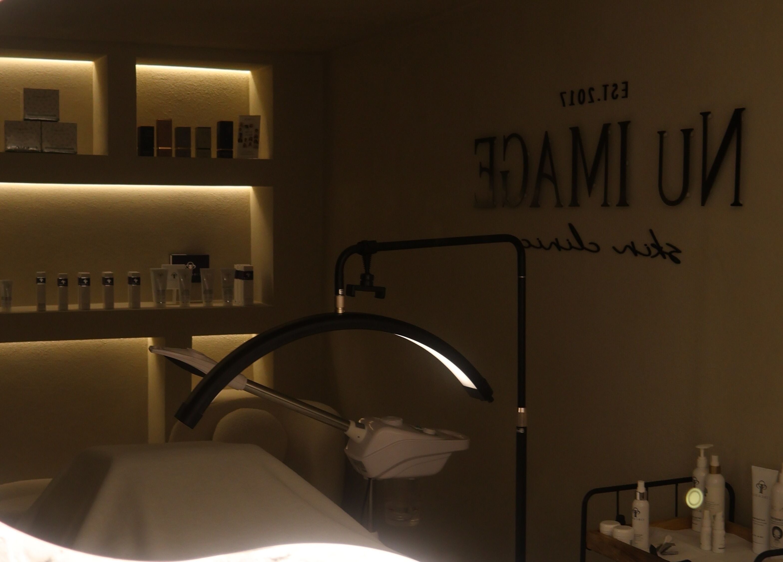 Elegantly lit treatment room at Nu Image, Lowton, England, GB with skincare products and tranquil ambiance.