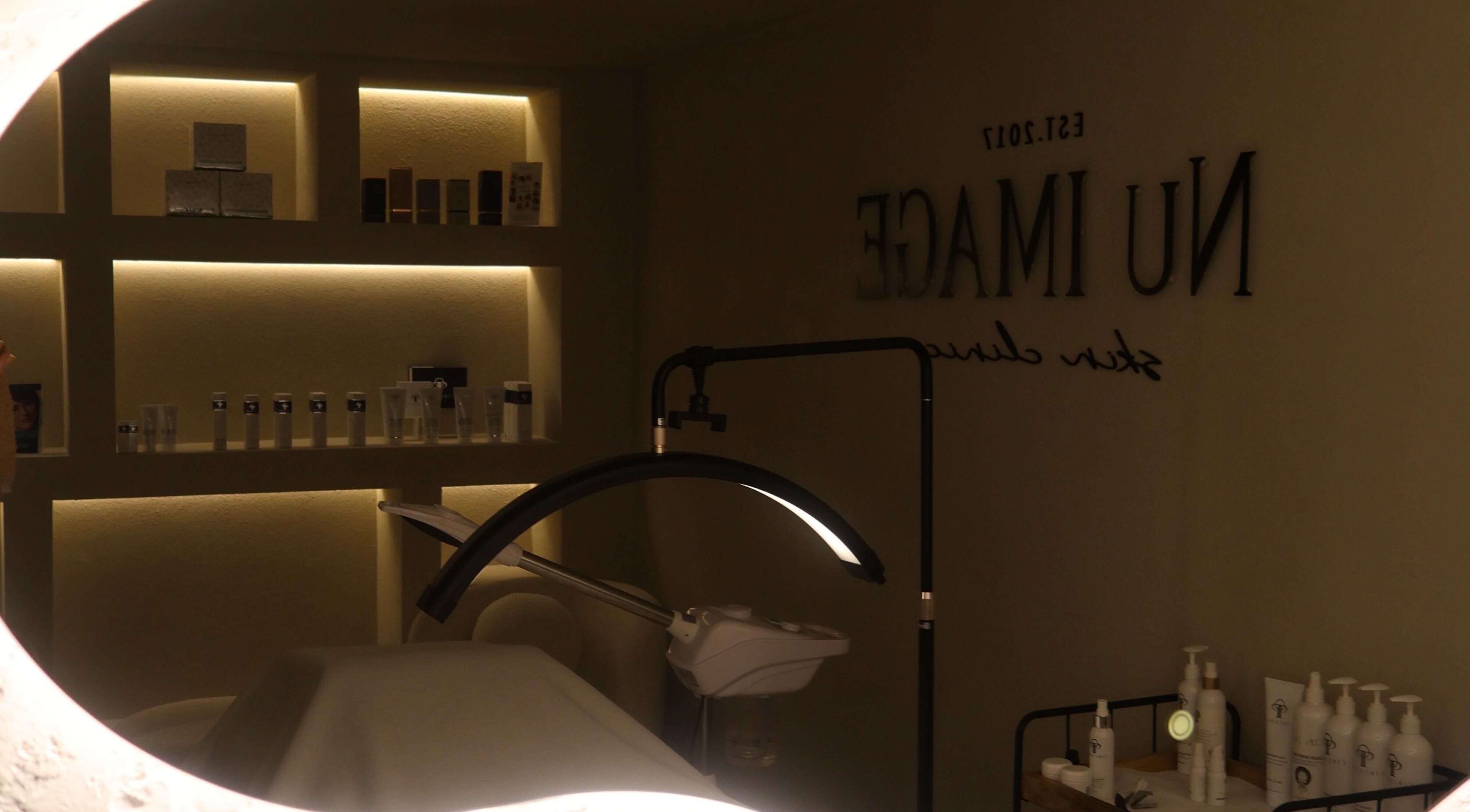 Elegantly lit treatment room at Nu Image, Lowton, England, GB with skincare products and tranquil ambiance.