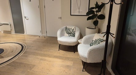 Modern chairs and decor in Ayma Therapeutics lounge, London, England, GB, offering a serene waiting area.