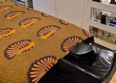 Massage table with vibrant linens at Ayma Therapeutics, London, England, GB, showcasing tranquil spa atmosphere.