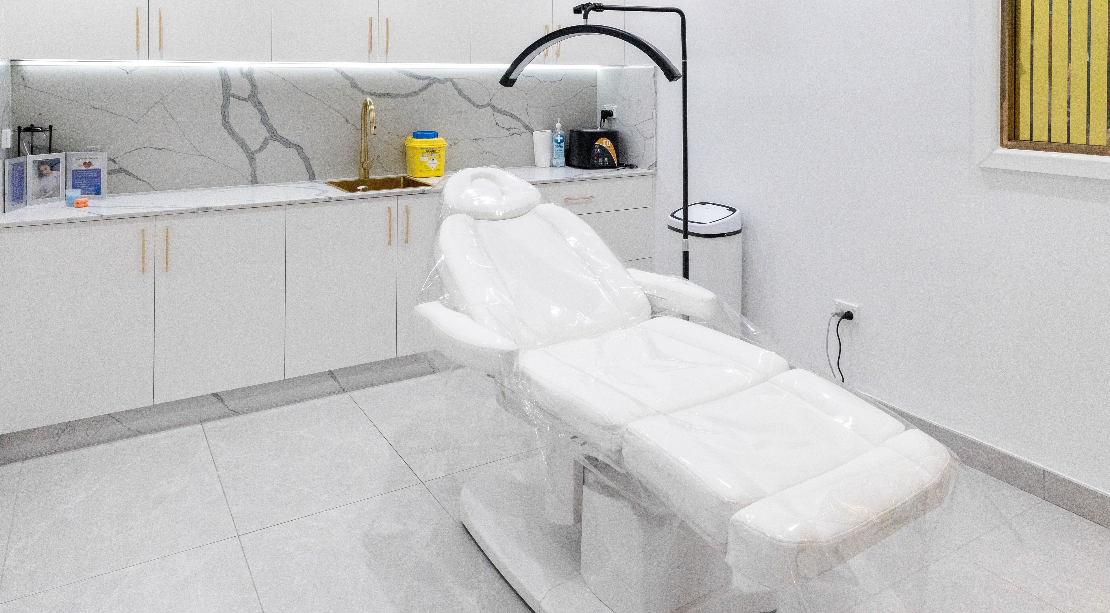 Luxurious treatment room at Crystal Beauty Bar, Fairfield, New South Wales, AU, with a sleek white spa bed.