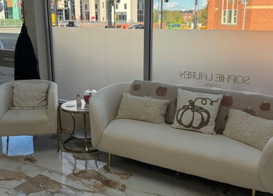 Elegant lounge area at Sophie Lauren Studios, Derby, England, GB with plush seating and decorative pillows.
