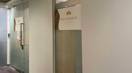 Entrance of Siam Botanical Thai Massage, Melbourne, Victoria, AU with elegant glass doors and signage.