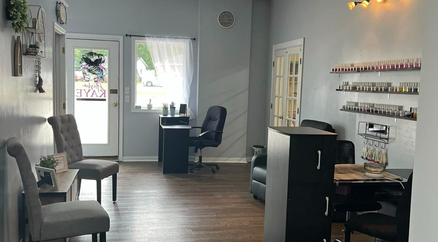 Chic interior of Alisha Kaye salon in Livingston, Tennessee, US with stylish chairs and nail polish display.