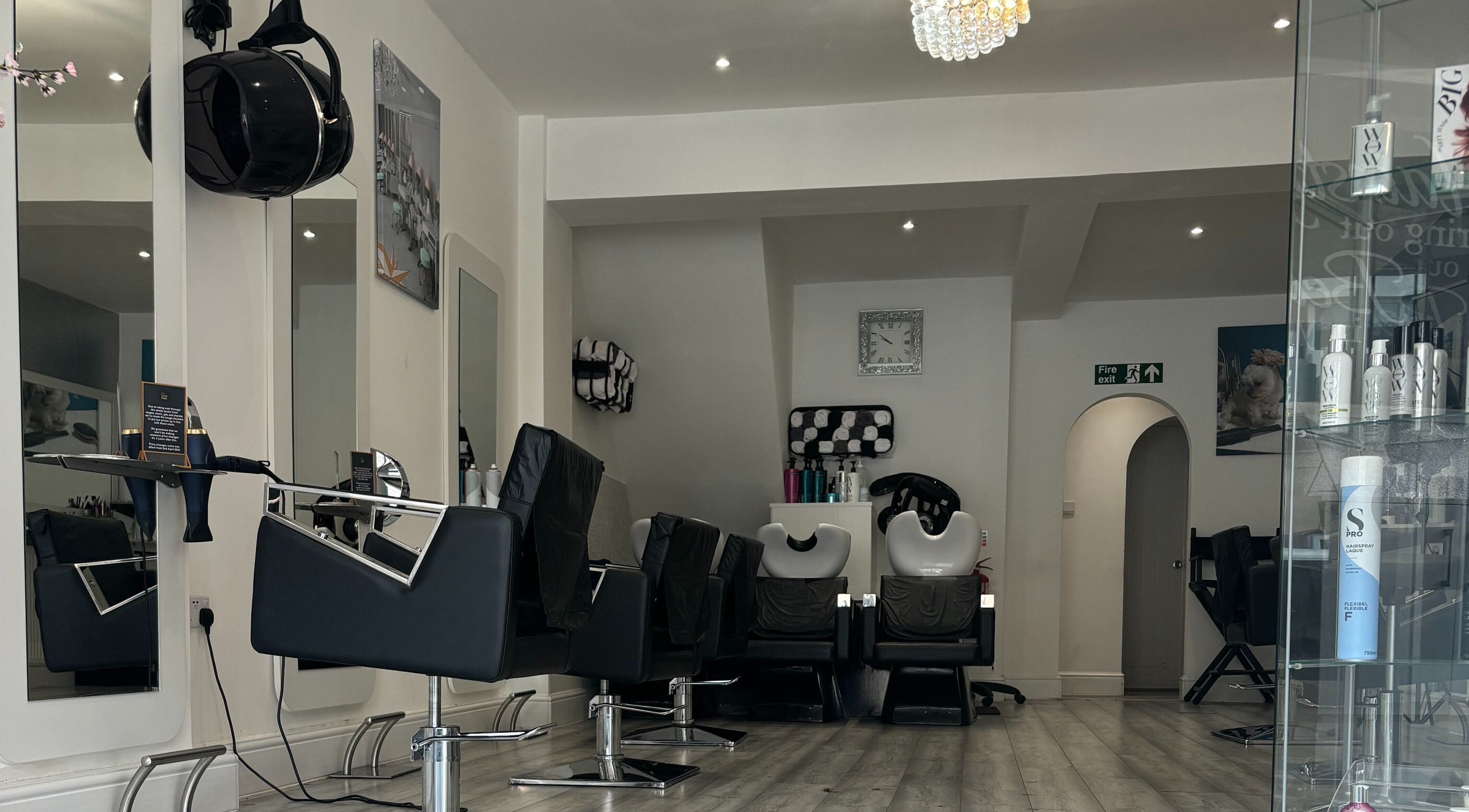 Modern interior of We Love Hair in Ellesmere Port, England, GB featuring stylish salon chairs and mirrors.
