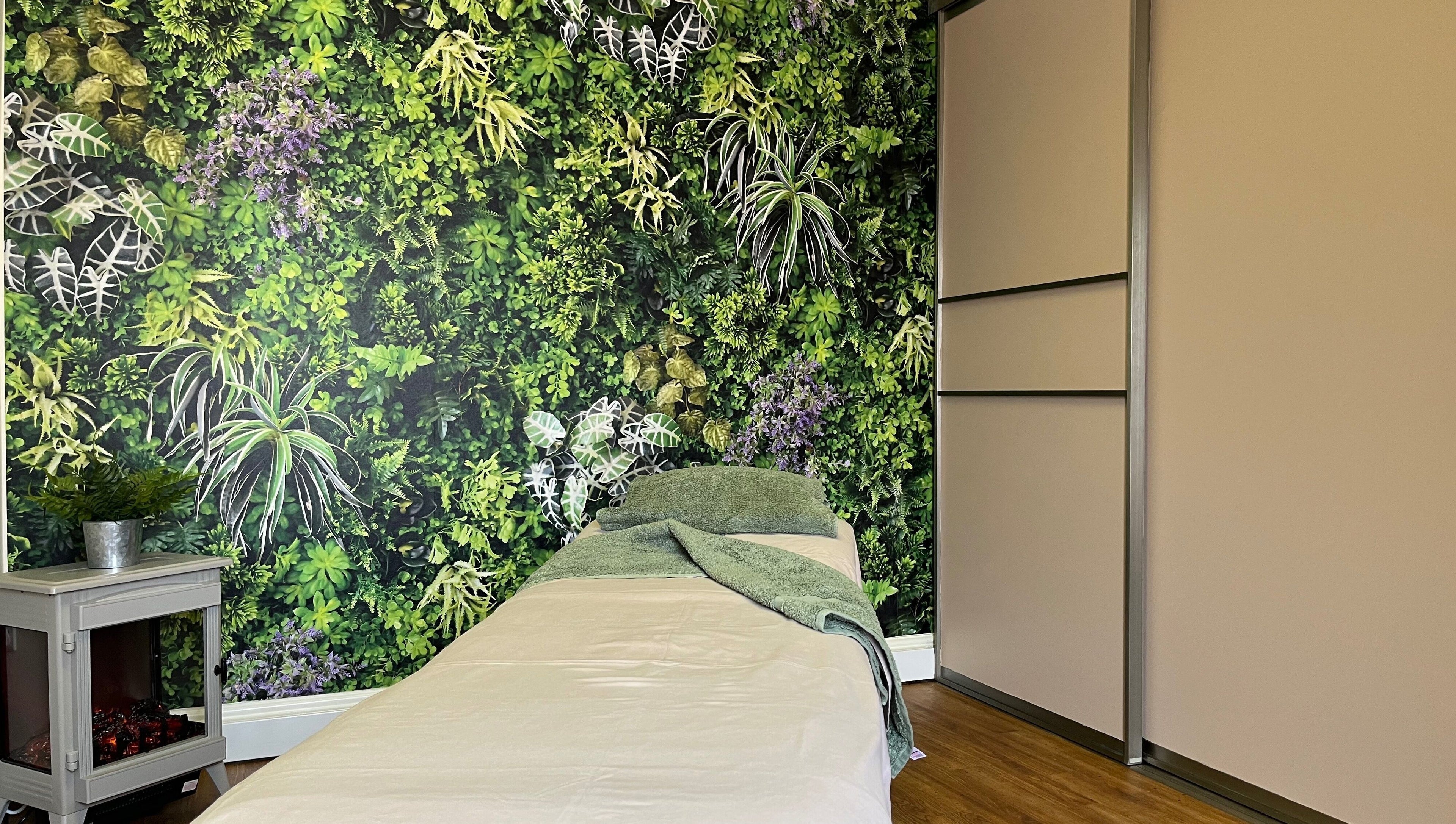 Tranquil therapy room at Fern Bodyworks in Hextable, England featuring lush greenery backdrop.