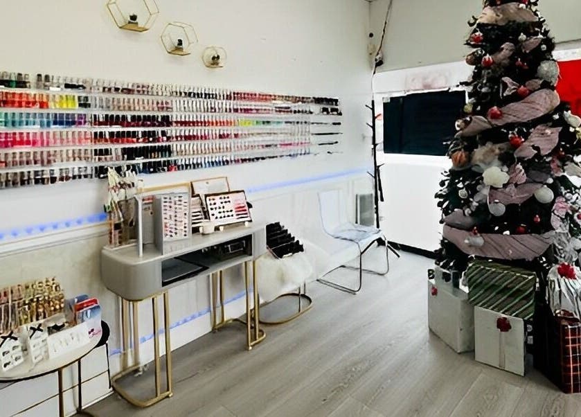 Top Q Nails in Markham, Ontario, CA, showcases a wall of polish colors and festive decor with a Christmas tree.
