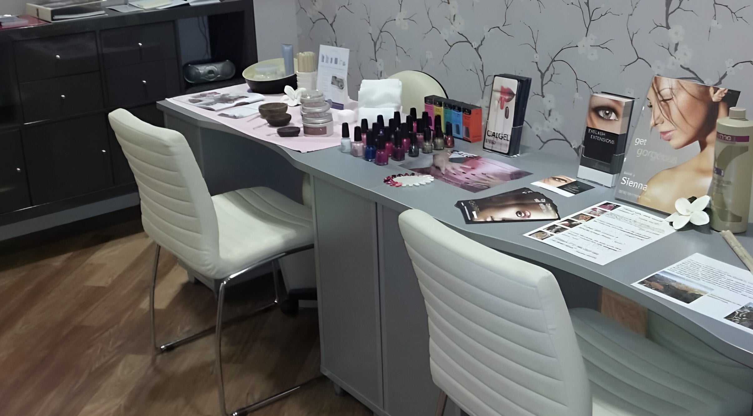 Modern nail salon at Baobab Tree Beauty, Belper, England, GB, showcasing manicure tools and vibrant nail polishes.