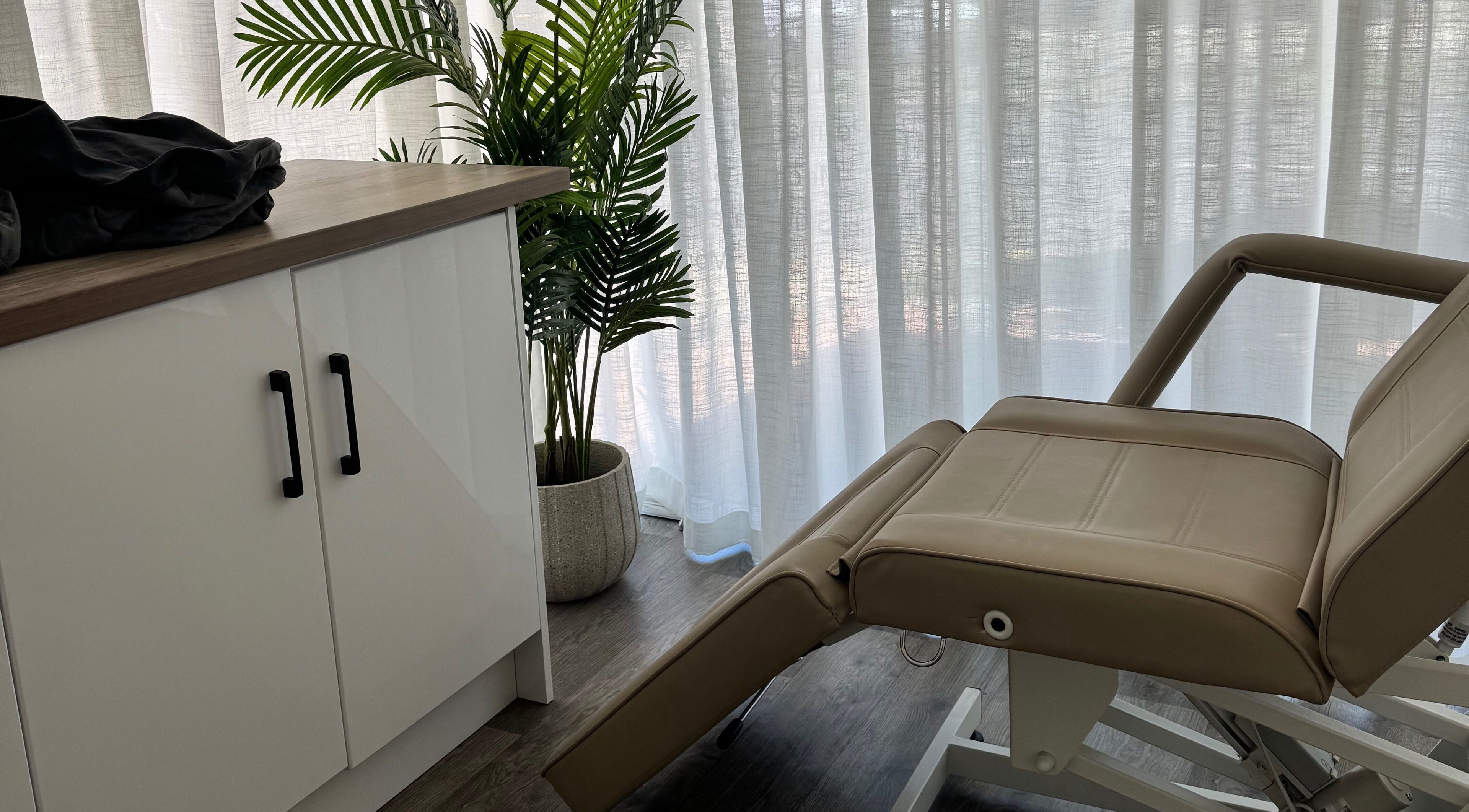 Tranquil treatment room at The Age Well Room, Maroochydore, Queensland, AU with soft lighting and elegant decor.