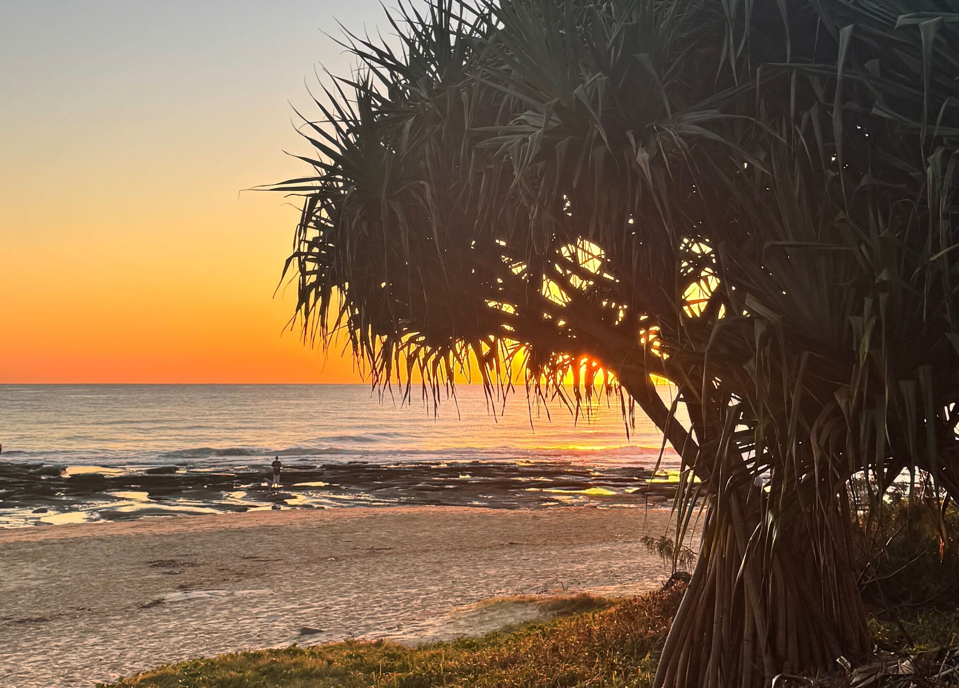 Stunning beach sunset at The Age Well Room near Maroochydore, Queensland, AU showcasing vibrant colors.