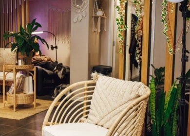 Inviting seating area at Hair by LAW, Worcester, England, GB with cozy decor and lush plants.