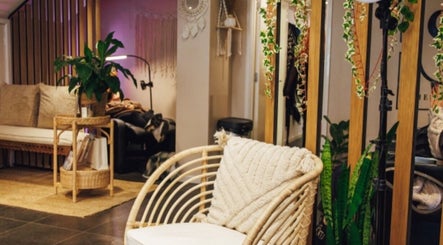 Inviting seating area at Hair by LAW, Worcester, England, GB with cozy decor and lush plants.
