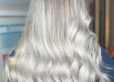 Elegant silver blonde waves at Hair by LAW in Worcester, England, GB. Perfectly styled hair capturing light.