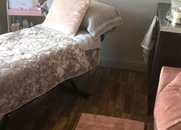 Cozy treatment room at ER Beauty Lounge, Rochdale, England, GB, featuring a plush treatment bed and elegant decor.