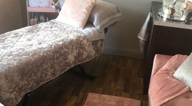 Cozy treatment room at ER Beauty Lounge, Rochdale, England, GB, featuring a plush treatment bed and elegant decor.