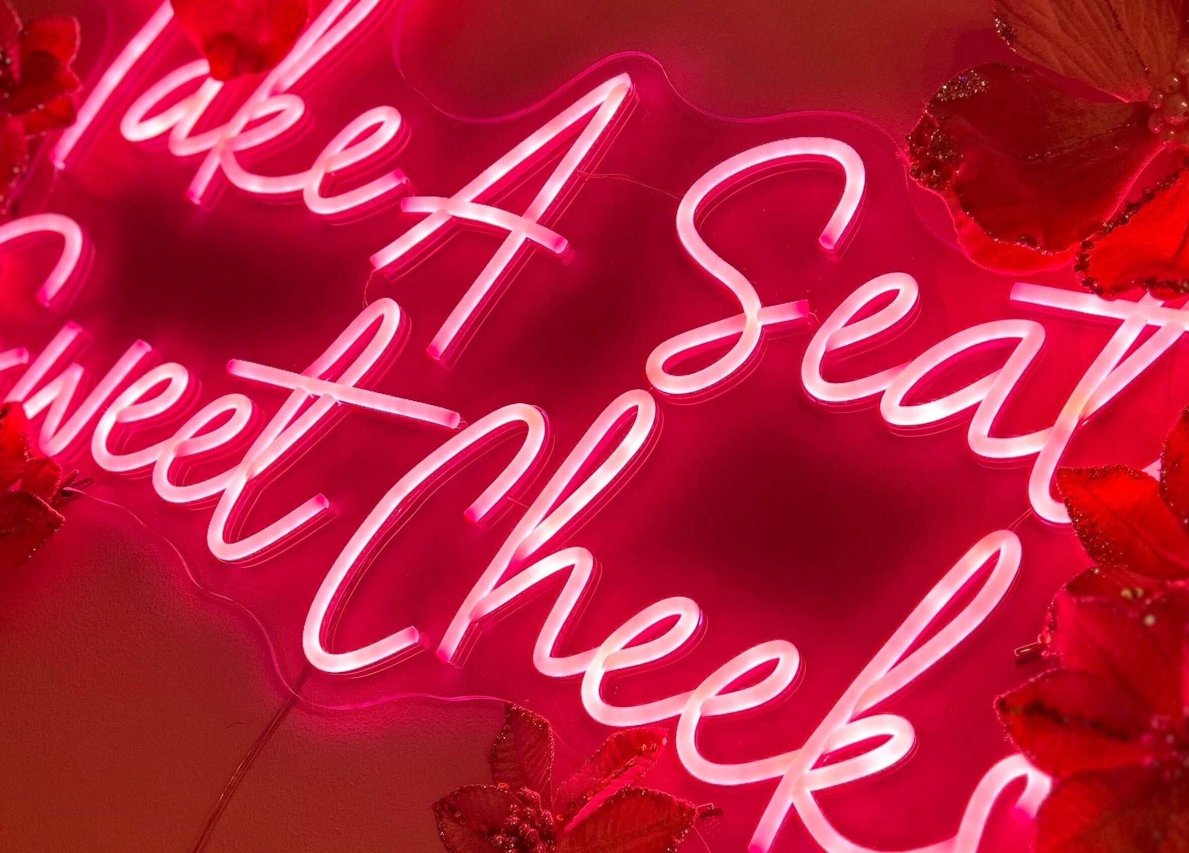 ER Beauty Lounge neon sign with pink flowers, Rochdale, England, GB accent decor.