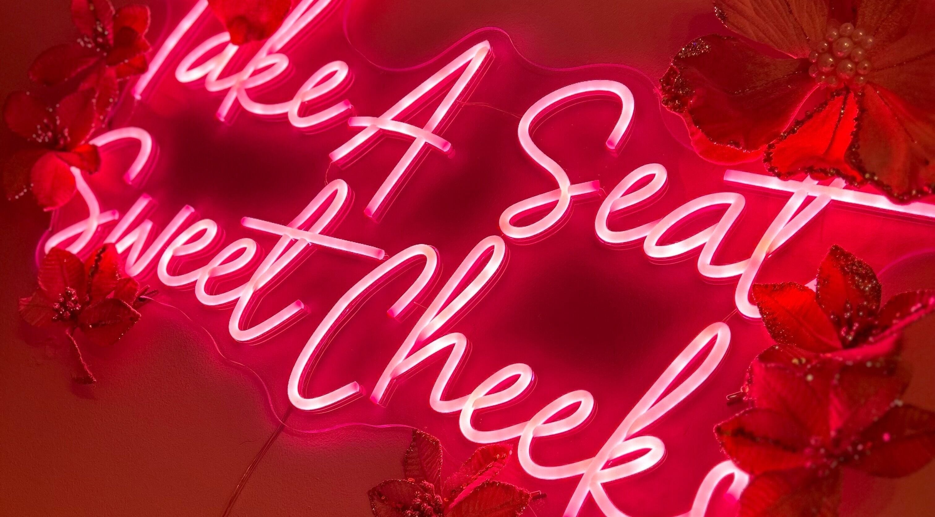 ER Beauty Lounge neon sign with pink flowers, Rochdale, England, GB accent decor.