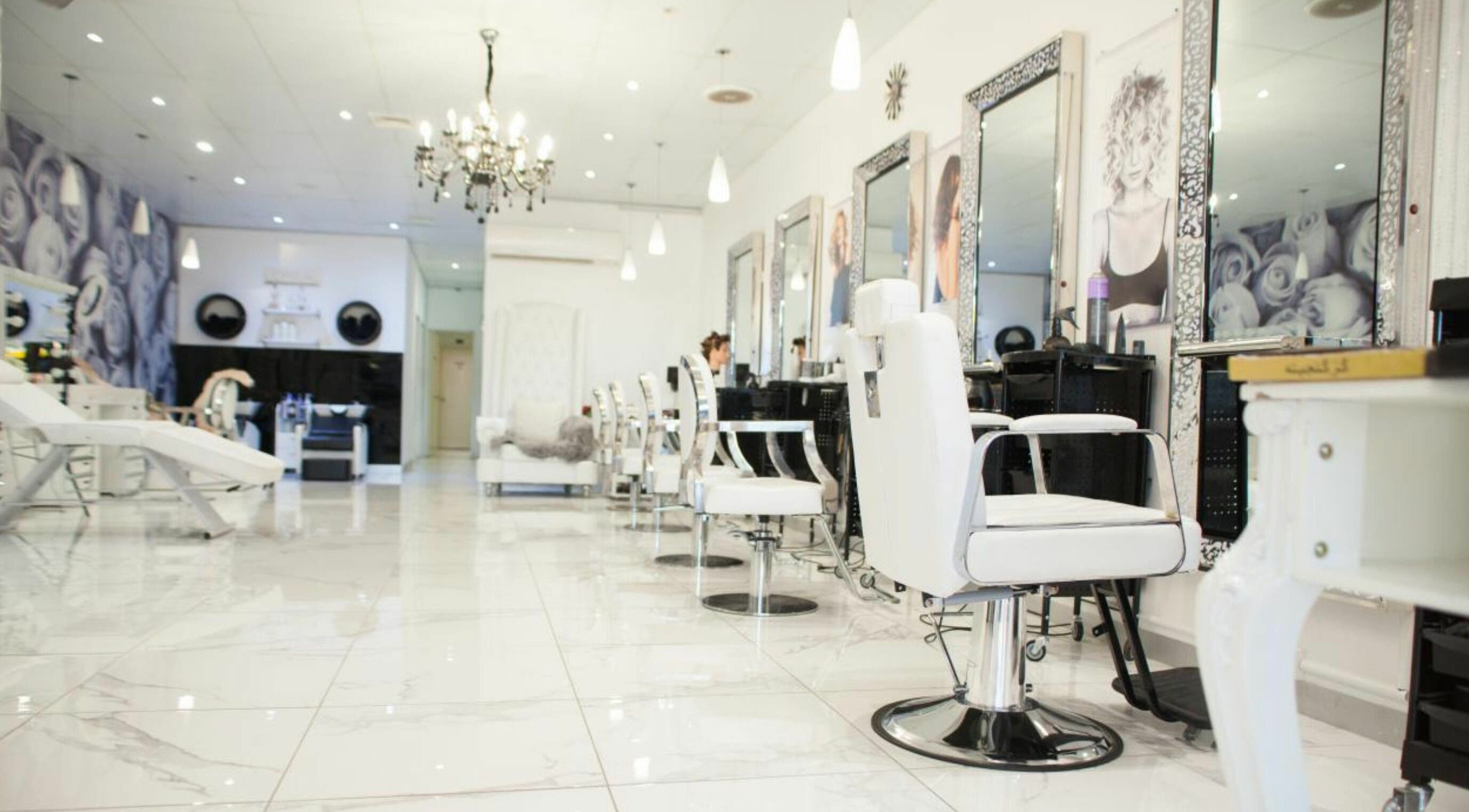 Alia Hair and Beauty salon in Melbourne, Victoria, AU features chic white decor and modern styling chairs.