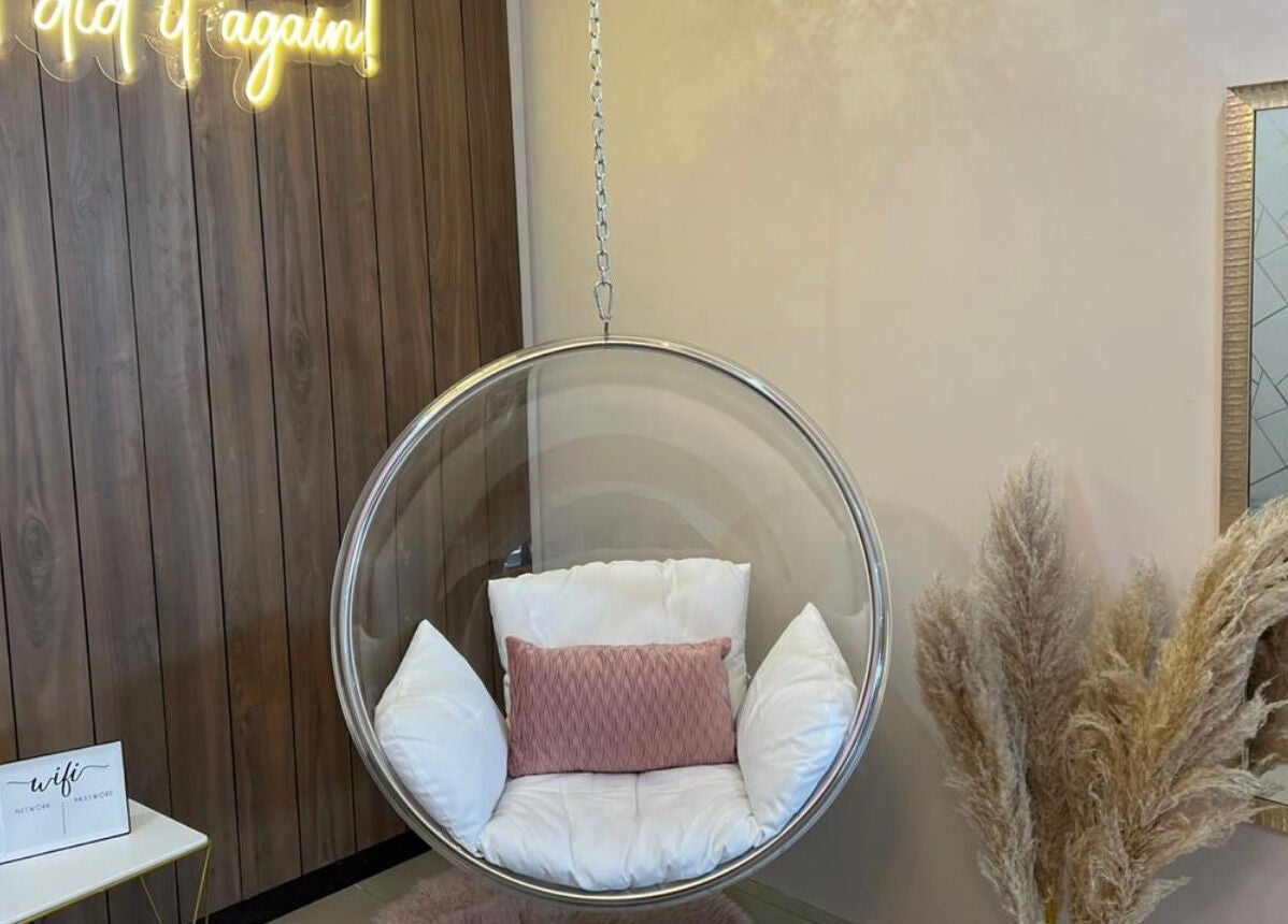 Espacio acogedor en Twelve Studio, Quito, Pichincha, EC con silla colgante y decoración elegante.