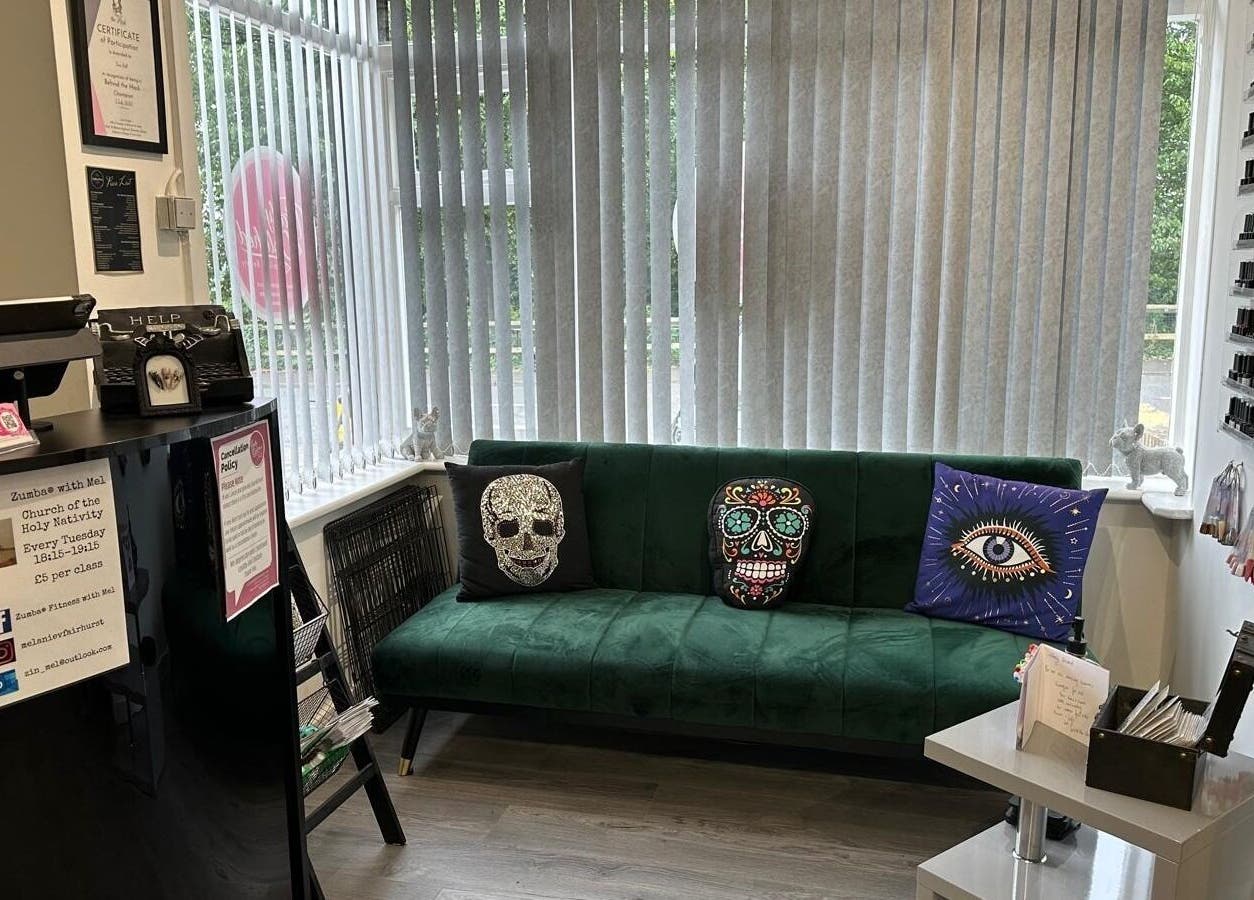 Cozy green sofa with eclectic pillows at Totally Polished, Village, England, GB.