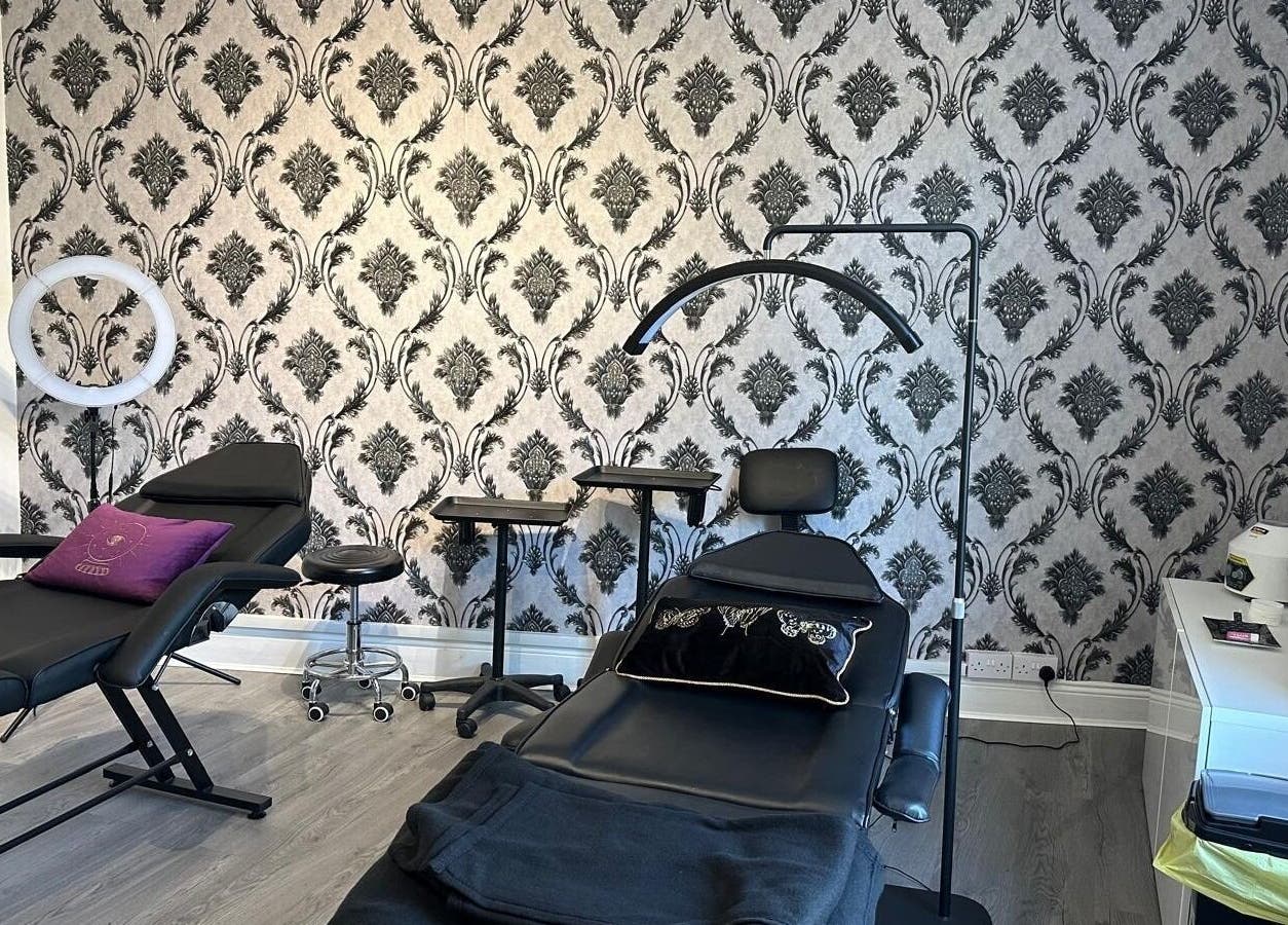 Sleek treatment room with black chairs at Totally Polished, Village, England, GB.