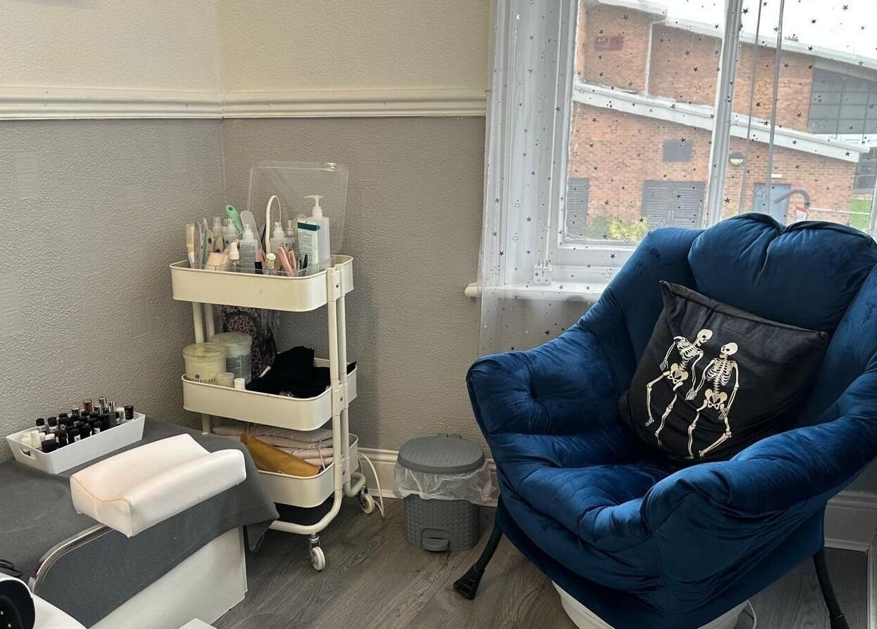 Relaxing corner with blue chair and nail care setup at Totally Polished, Village, England, GB.