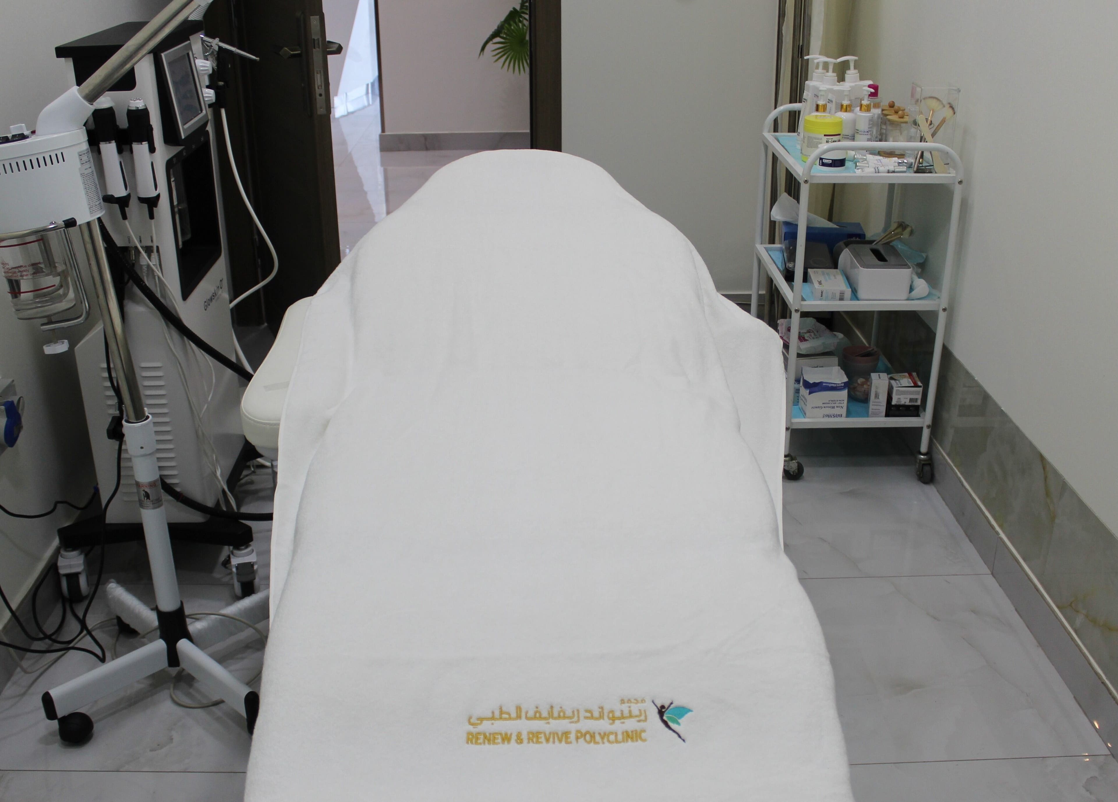 Treatment room at Renew and Revive Polyclinic, Dubai, Dubai, AE, featuring a massage table and equipment.