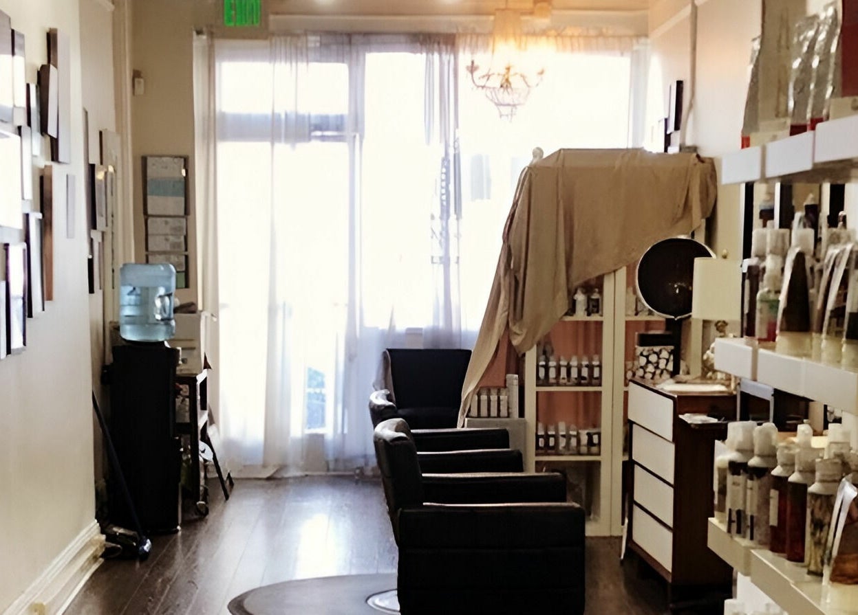 Charming interior of Dolled and Dapper Salon in San Francisco, California, US, featuring stylish chairs and shelves.