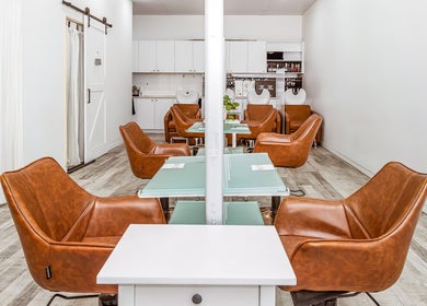 Chic interior of Elixir Hair & Beauty salon on Gold Coast, Queensland, AU featuring stylish leather chairs.