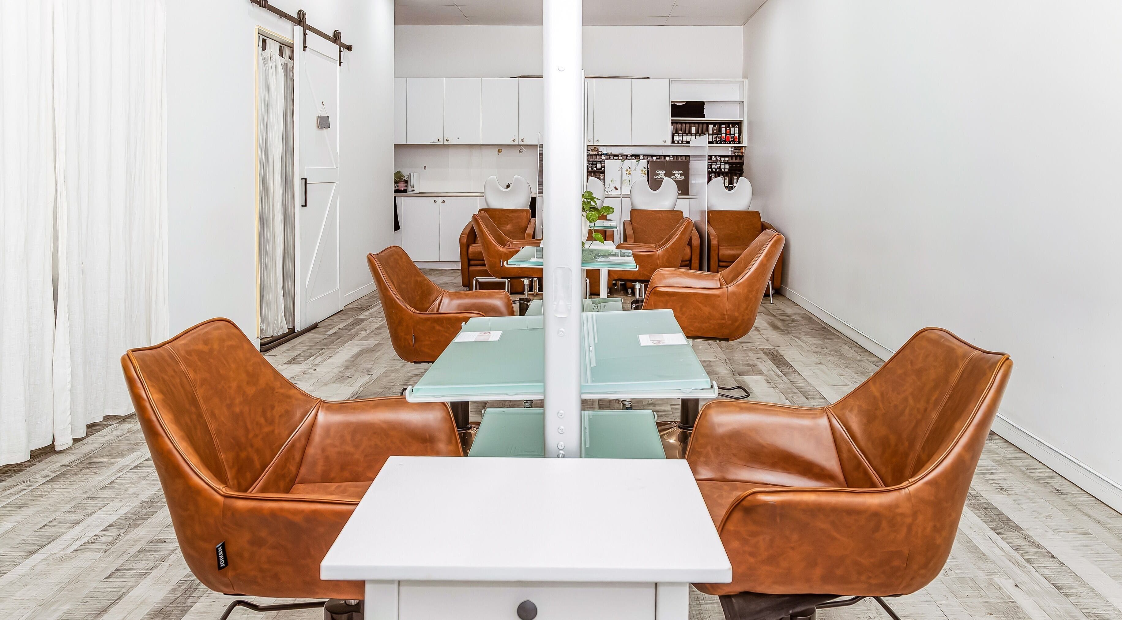 Chic interior of Elixir Hair & Beauty salon on Gold Coast, Queensland, AU featuring stylish leather chairs.