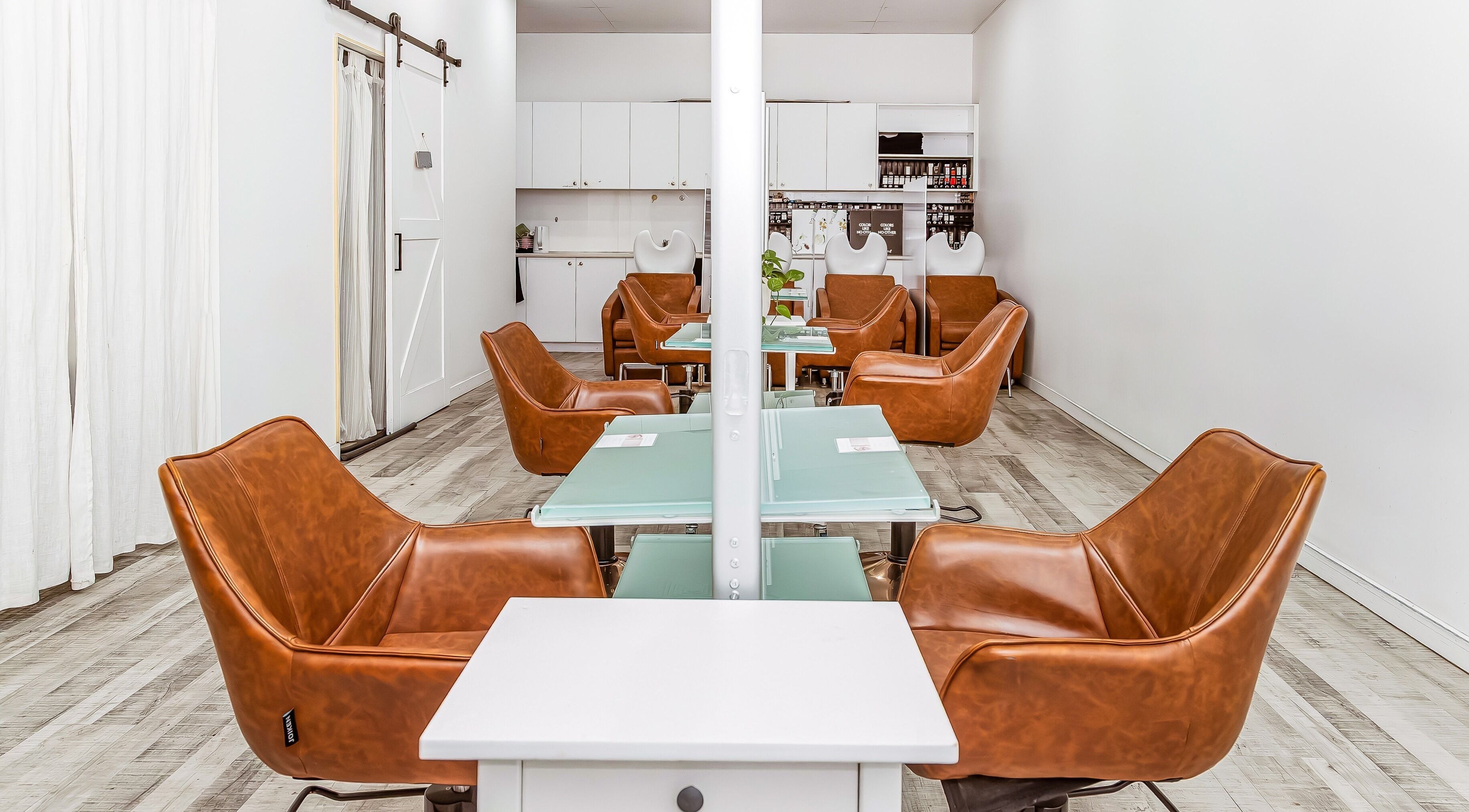 Chic interior of Elixir Hair & Beauty salon on Gold Coast, Queensland, AU featuring stylish leather chairs.