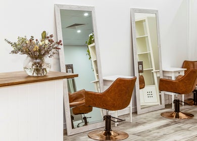 Chic salon chairs and mirrors at Elixir Hair & Beauty, Gold Coast, Queensland, AU, creating a stylish atmosphere.