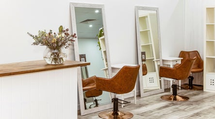 Chic salon chairs and mirrors at Elixir Hair & Beauty, Gold Coast, Queensland, AU, creating a stylish atmosphere.