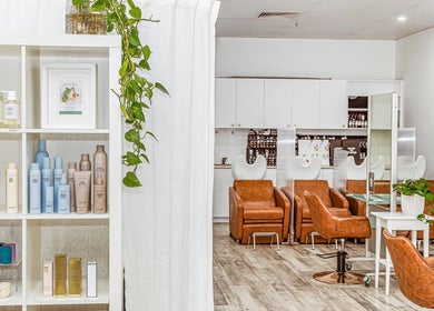 Cozy salon chairs and product display at Elixir Hair & Beauty, Gold Coast, Queensland, AU.
