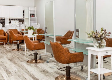 Modern interior of Elixir Hair & Beauty on Gold Coast, Queensland, AU with chic chairs and styling stations.