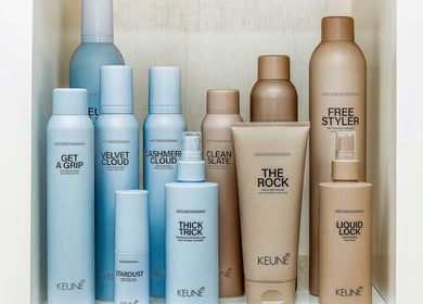 Hair products at Elixir Hair & Beauty, Gold Coast, Queensland, AU displayed on a white shelf.