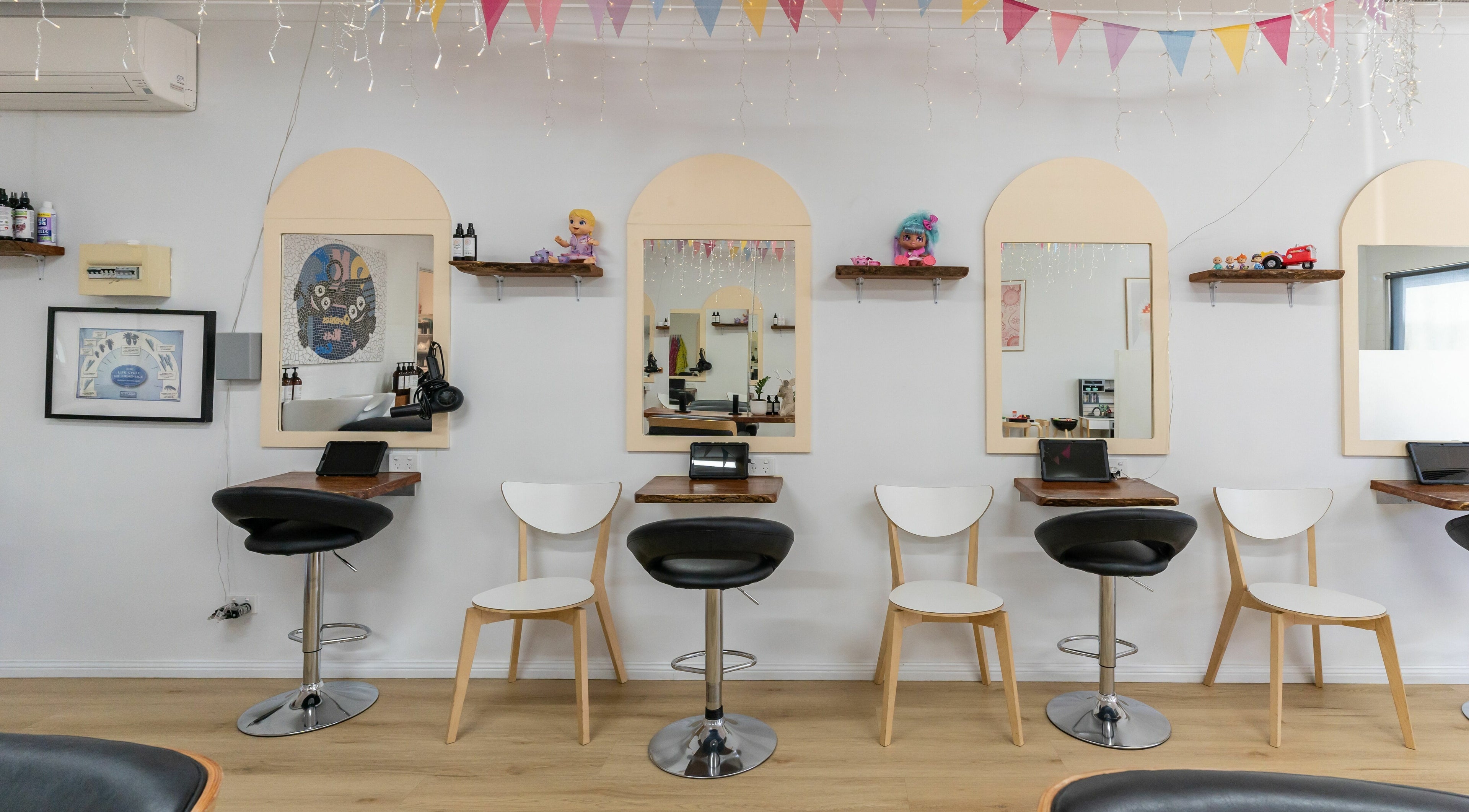 Interior view of Deanies Kids Cuts in Currimundi, Queensland, AU, featuring colorful decor and child-friendly seating.