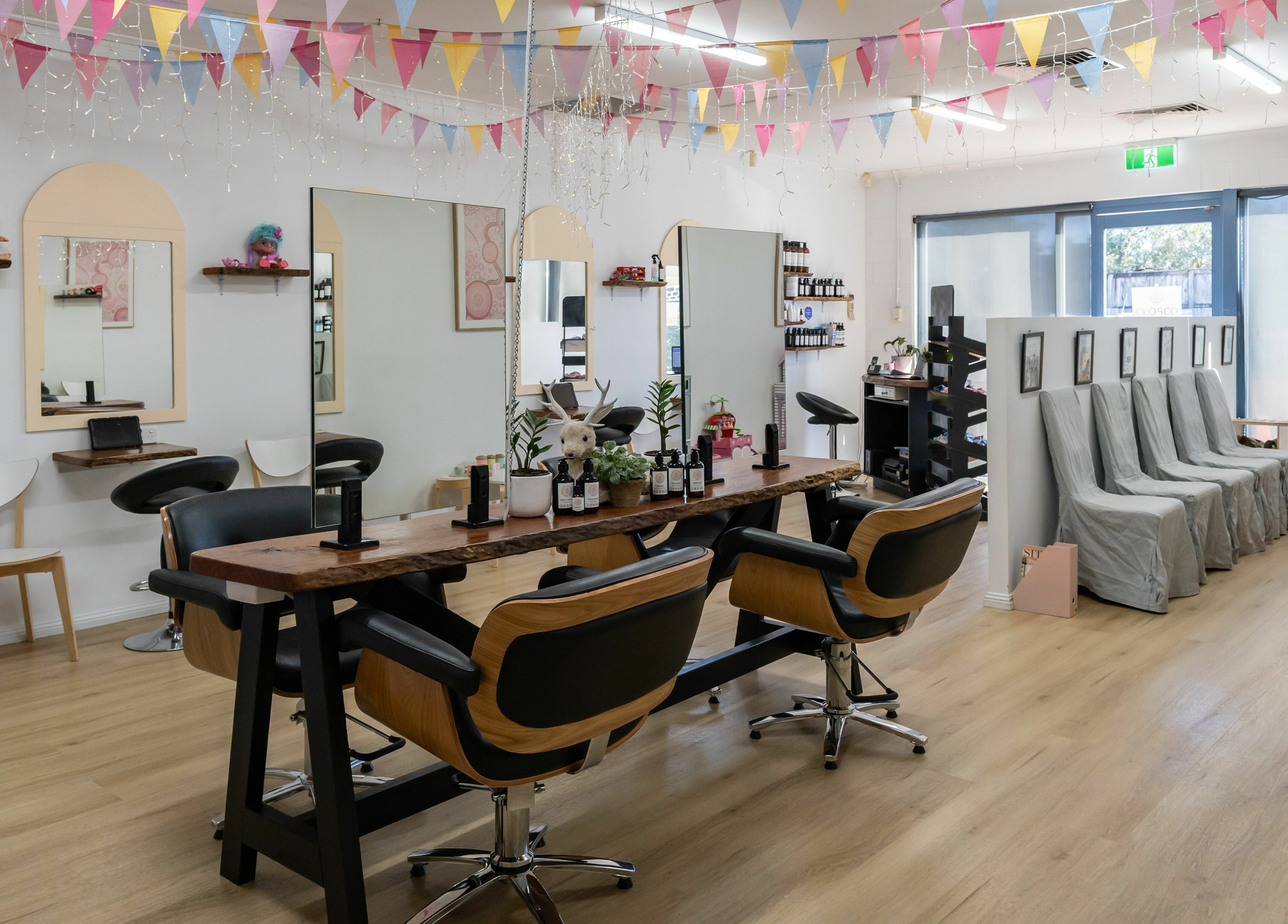 Inside Deanies Kids Cuts, Currimundi, Queensland, AU: stylish salon with colorful decor and comfy seating.