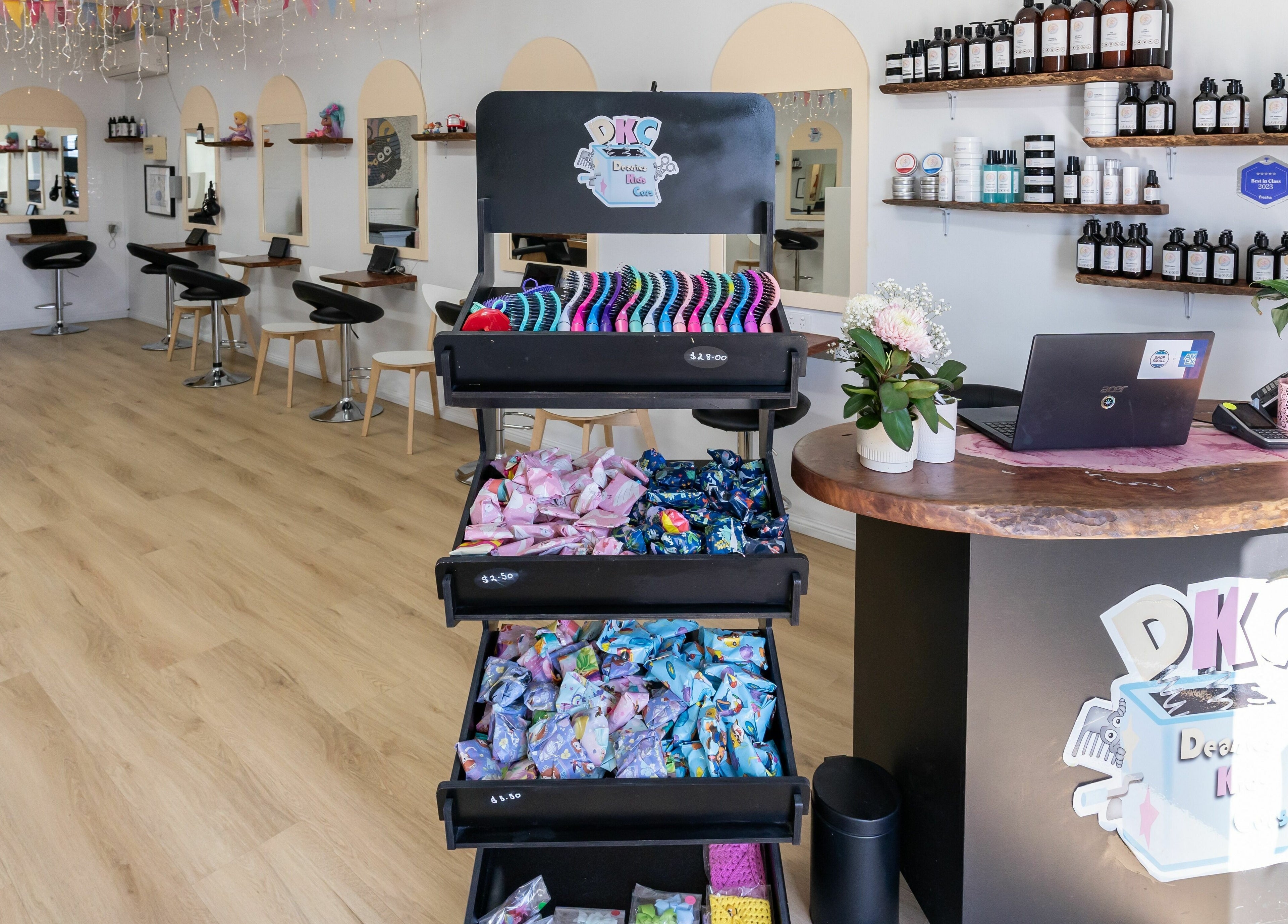 Bright interior of Deanies Kids Cuts in Currimundi, Queensland, AU, showcasing playful decor and styling stations.