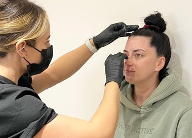 Professional beauty treatment at Lucy's Beauty Bar, Allington, England, GB. Expert applying precise care.