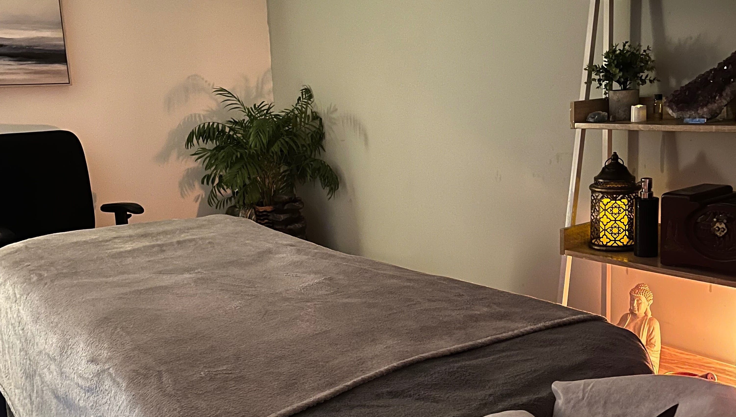 Calm therapy room at Jenny Lockyer Reflexology, Gosport, England, GB, with gentle lighting and soft textures.