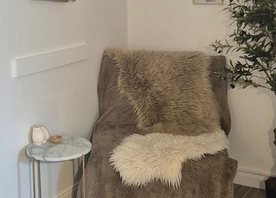 Cozy corner at The SKN Edit (Nude Studio) in Cockenzie Port Seton, Scotland, GB featuring soft furs and greenery.