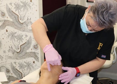 Professional aesthetician performing a facial treatment at Warwickshire Aesthetics Collective, Stratford-upon-Avon, England, GB.
